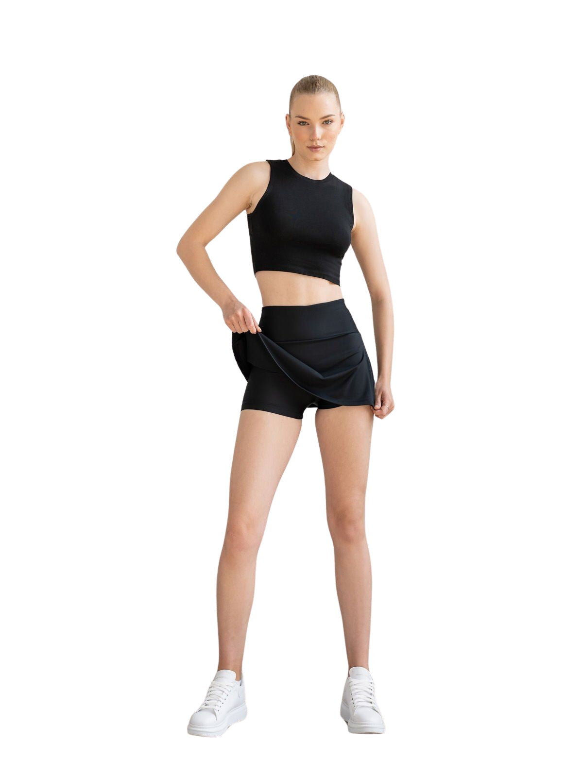 Frau trägt den 440 Rock in Schwarz von Lismina und zeigt einen sportlichen Look vor weißem Hintergrund.