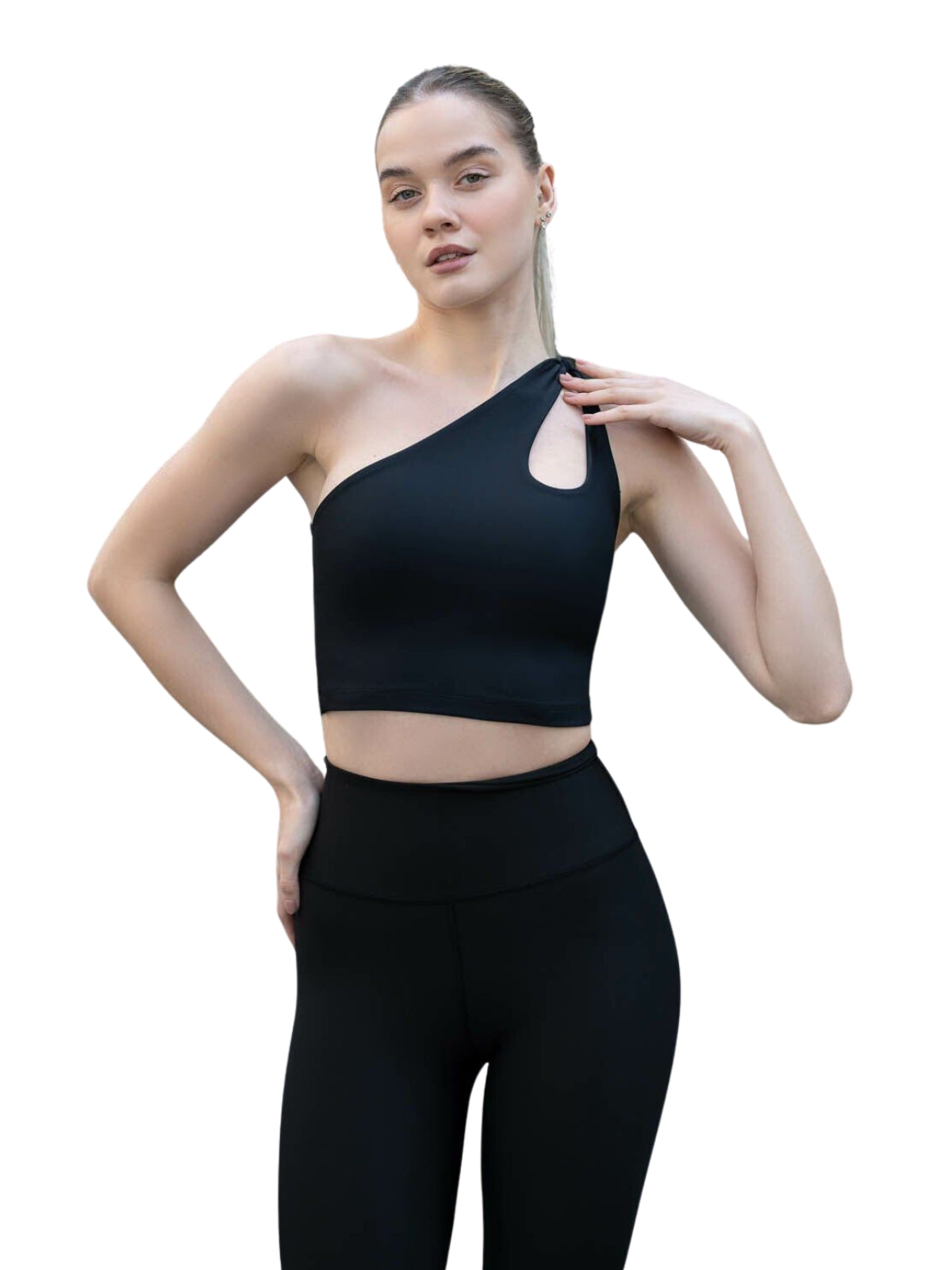 Person, die in einem Lismina 388 Sevres Sport Bustier in Schwarz posiert, bereit für Yoga vor einem schlichten Hintergrund.