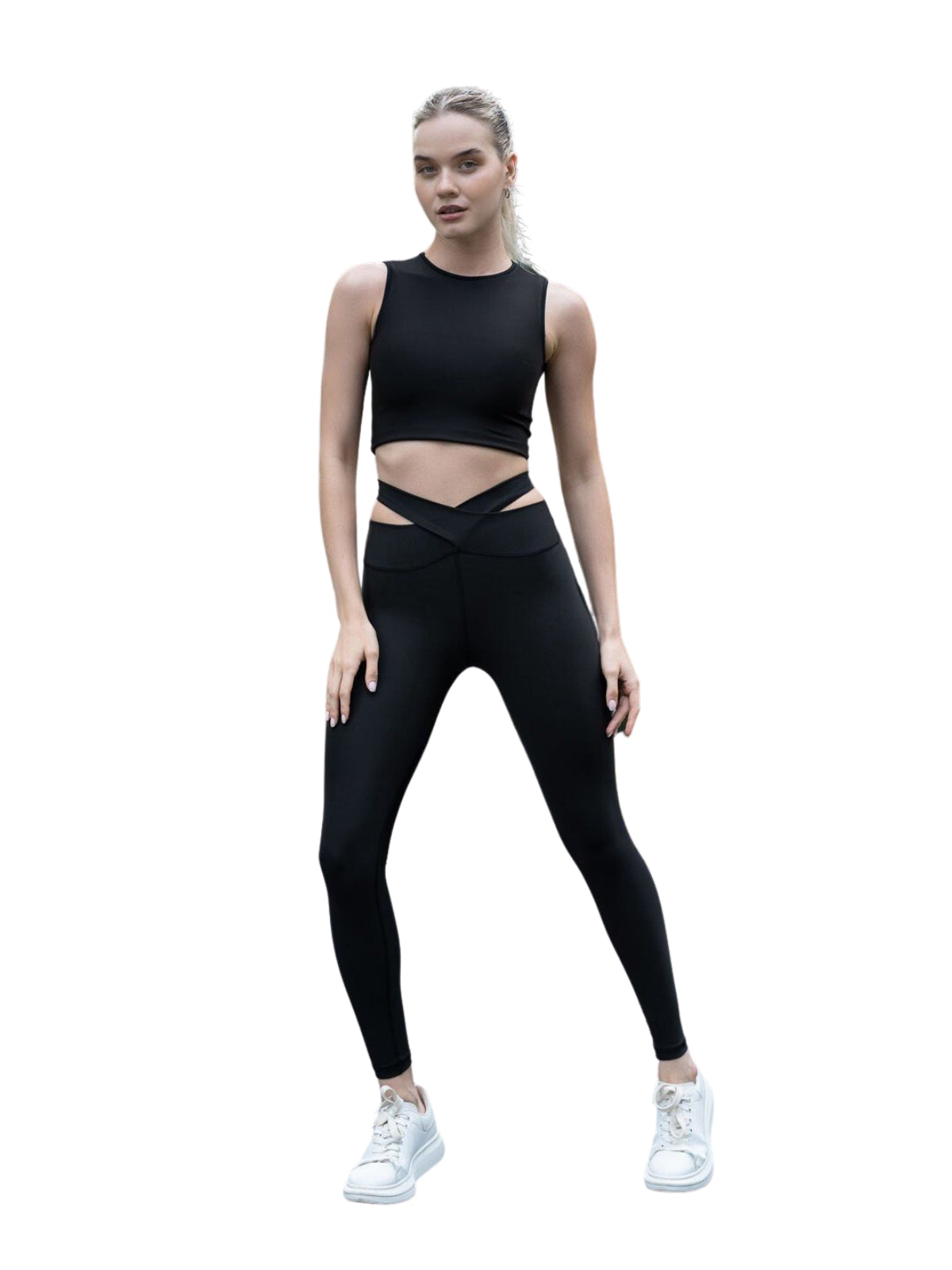 Eine Person präsentiert selbstbewusst Lisminas 814 Extra High Waist Leggings mit Hüftausschnitt in Schwarz vor weißem Hintergrund.